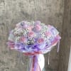 Bouquet of pink roses with white baby's breath and lavender wrapping