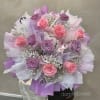 Bouquet of pink and purple roses wrapped in lavender paper