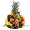 Tropical fruit arrangement with a pineapple, bananas, apples, and pears