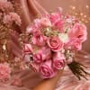Pink rose bouquet with white filler flowers and ribbon accents