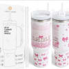 White handled tumbler with pink bow and mama text design beside branded box and straws