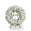 White floral wreath on a standing easel