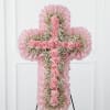 Pink floral cross-shaped standing spray with carnations and baby's breath