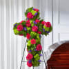 Cross-shaped floral spray with pink roses and bright green and purple flowers