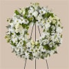 White floral wreath on a black easel stand