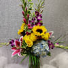 Gladiolus, Orchids, Sunflowers, Hydrangeas, Stargazer Lily, Roses, Willow, and Variegated greenery