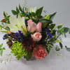 Mixed bouquet with pink roses, white lilies, and colorful blooms
