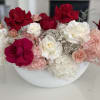 Red and white roses with pink hydrangeas in a white bowl