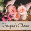 Pink and peach roses with anemones in a hand-held bouquet