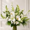 White orchids and lilies arranged in a clear glass vase