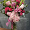 A vibrant arrangement filed with hot pink lilies , soft light pink