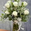 Classic White Roses 
A Timeless arrangement of white roses, accented with baby&rsquo;s
