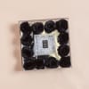 Square box of black roses with a clear jeweled center