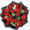 Bouquet of red roses wrapped in black paper