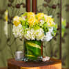 Yellow roses and white hydrangeas in a glass vase