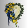 Heart-shaped floral wreath with white chrysanthemums, yellow and blue roses, and a blue ribbon