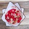 Bouquet of pink and red roses wrapped in white paper