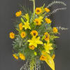 Tall yellow floral spray with lilies and daisy-like blooms on a stand