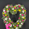 Heart-shaped floral wreath with white, pink, and yellow flowers