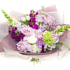 Bouquet of lavender roses and purple flowers wrapped in pink paper