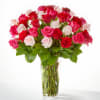Bouquet of pink, red, and white roses in a clear glass vase