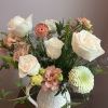 This is a medium height arrangement filled with white and pastel colors.