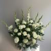 White roses and carnations in a white vase