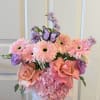 A pastel hat box arrangement that reads like a love letter: soft
