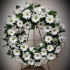 White daisy wreath on a black stand