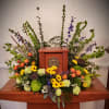 A woodsy creation of bells of ireland, roses, viking daisies, dianthus, carnations