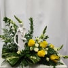 A keepsake memorial Angel is placed in a garden of beautiful blooms.