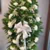 White floral standing spray with a satin bow