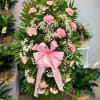 This Sympathy Standing Spray in pink, is a beautiful symbol of your
