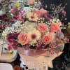 Pink and white mixed bouquet wrapped in pale paper with ribbon