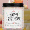 Birthday candle in a glass jar with a black lid