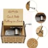 Wooden music box with engraved "Can't Help Falling in Love" text