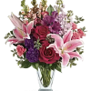 Hand-delivered in a shapely glass vase, this sumptuous arrangement of roses and
