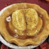 Foil pan holding a yellow molded dessert with a glossy topping