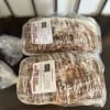 Two packaged loaves of cinnamon pull-apart sweet bread on a table.