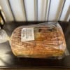 Wrapped loaf of jalapeño cheddar sourdough bread on a chair
