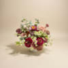 A compact, rounded flower arrangement that feels like a pocket of summer-perfect