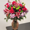 Pink and red flower arrangement in a vase