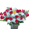 Bouquet of red, white, and yellow roses in a glass vase