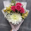 Our petite Pink Breeze hand-tied bouquet features cheerful mums, spray roses, daisies