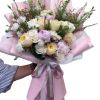 Pale cream and white roses mingle with peonies, soft pink carnations and