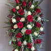 Featuring a thoughtful blend of red and white flowers, this arrangement conveys
