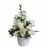 White floral arrangement in a white woven basket with a handle