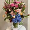 Luxury flower arrangement handcrafted with premium blue hydrangeas, pink roses, tulips, ranunculus
