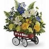 Mixed flower arrangement in a red wagon with white wheels