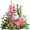 Pink floral arrangement with a white urn centerpiece